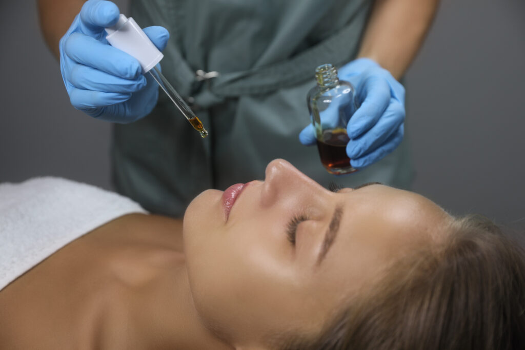 cosmetologist applying serum client39s face salon